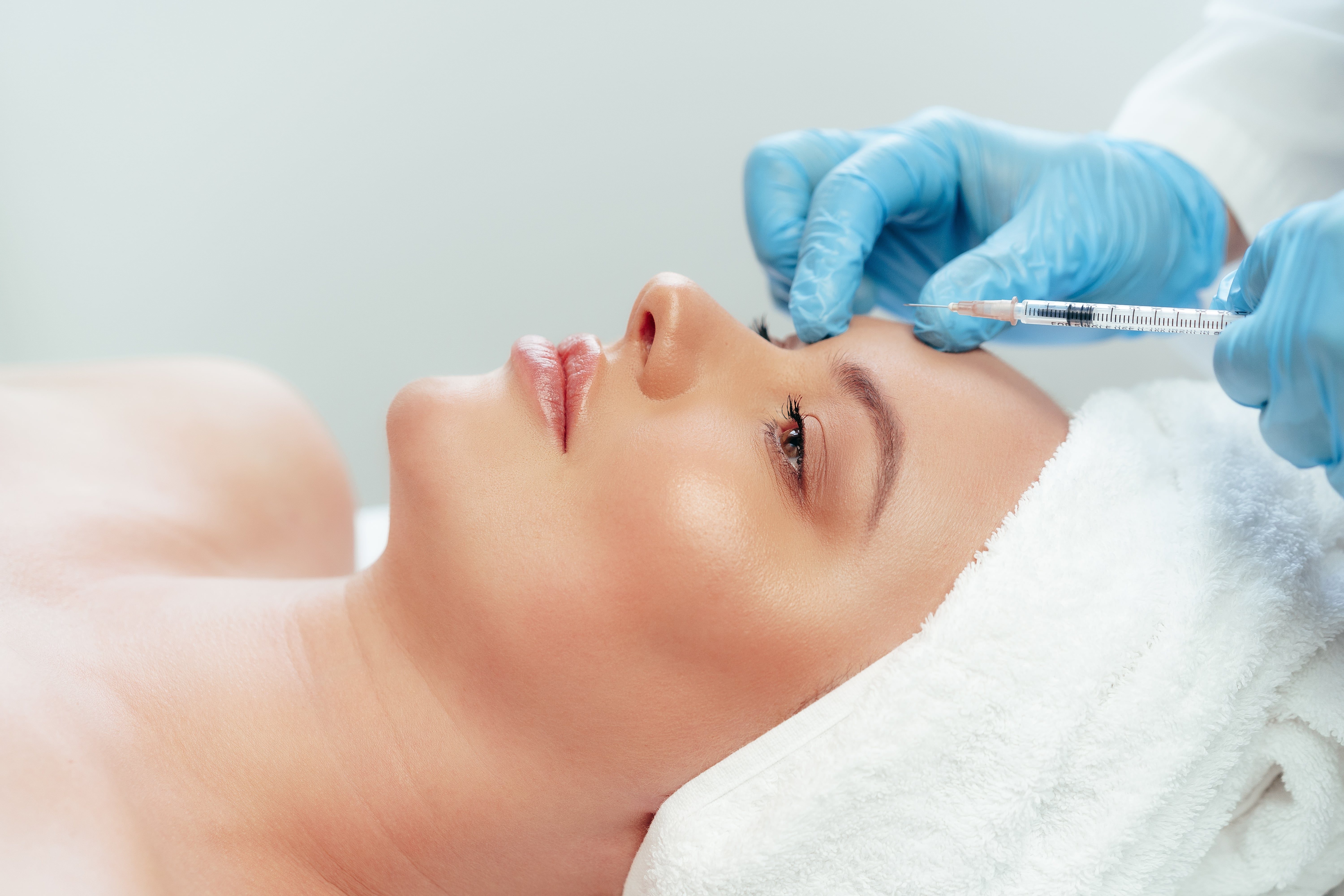 A nurse injects a patient with a peptide injection at elegant hoopoe in the UAE
