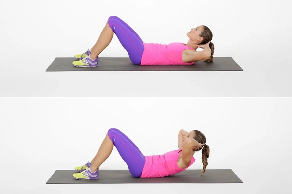 Woman doing crunches in pink activewear to target abdominal fat