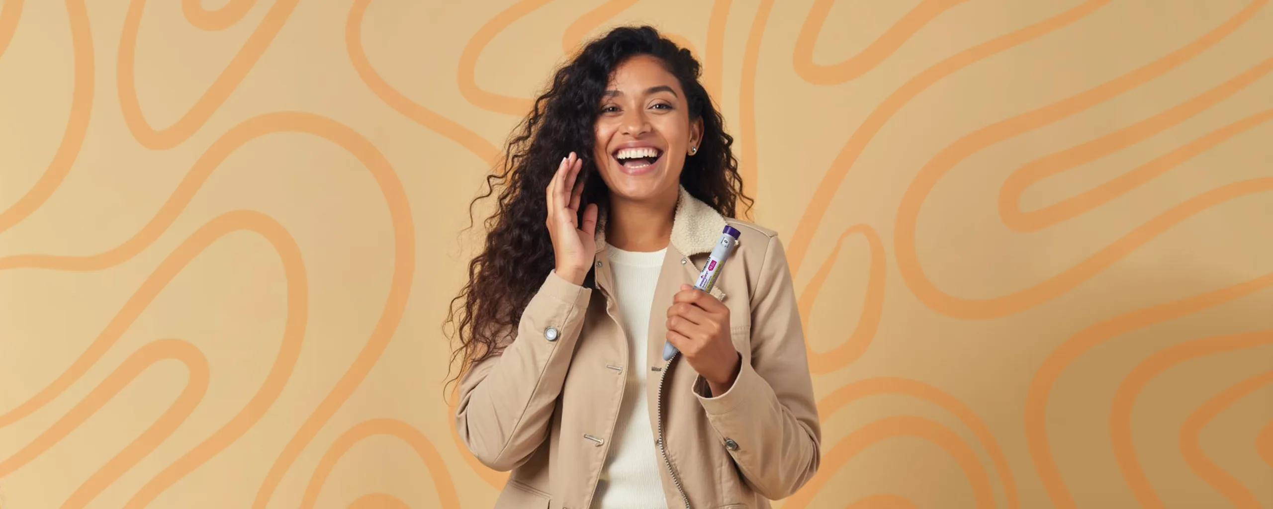 A woman laughing with a Mounjaro injection pen in her hand