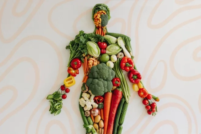 Creative human figure made from assorted fresh vegetables, symbolizing healthy foods that help reduce cellulite naturally.