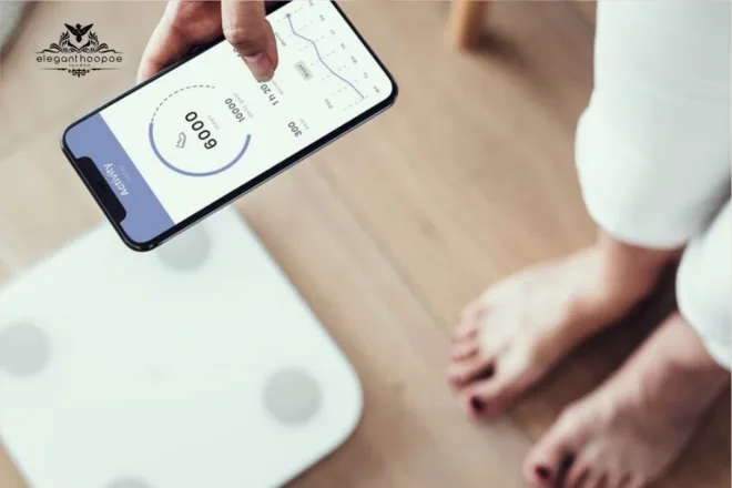 A person checking BMI and weight data on a smartphone app connected to a smart scale.