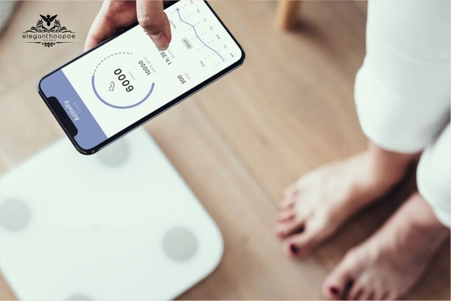 A person checking BMI and weight data on a smartphone app connected to a smart scale.