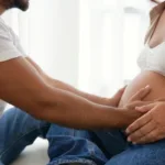 Man and woman touching pregnant belly together