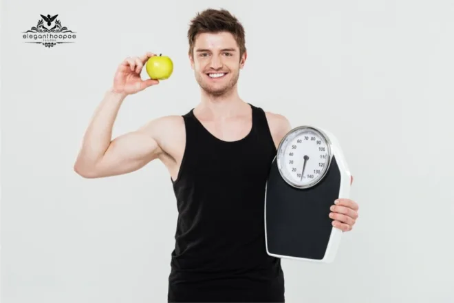 Smiling man holding weighing scale and green apple to support BMI awareness.