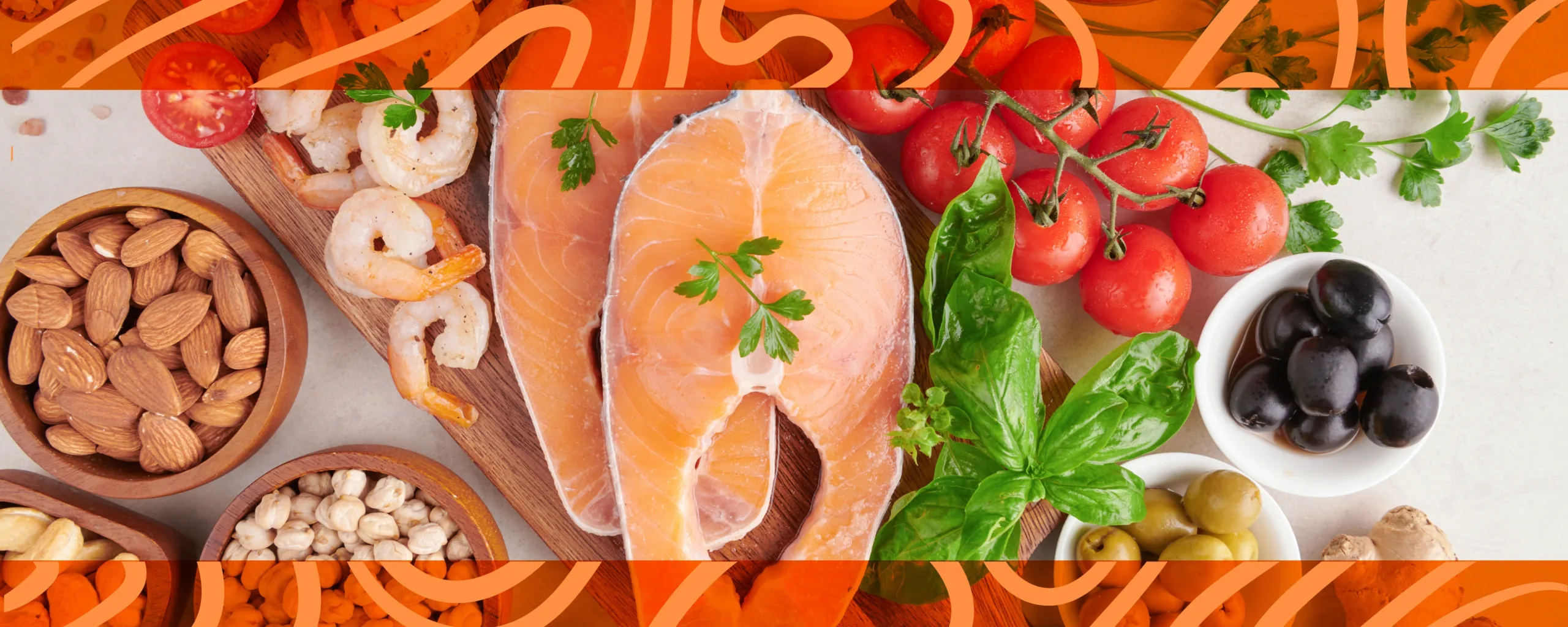 Assorted paleo diet foods including salmon, nuts, and fresh vegetables arranged on a table.