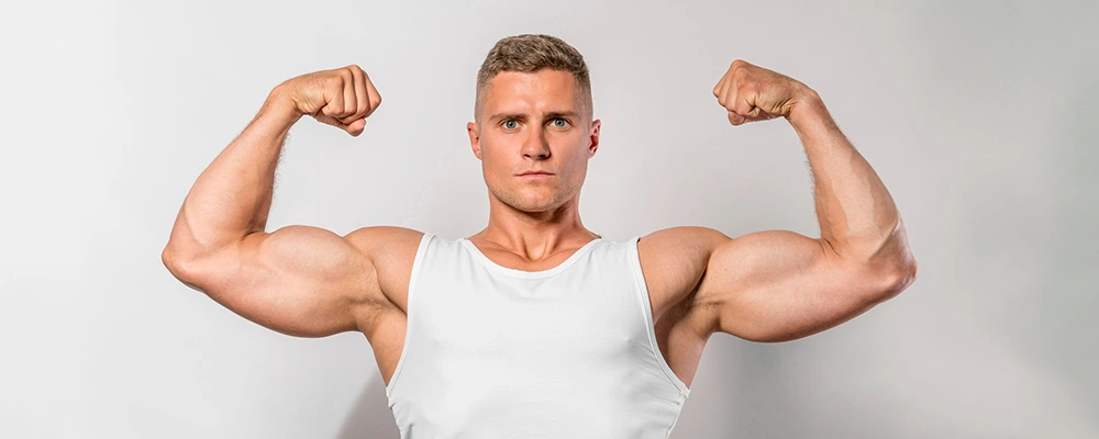 Muscular man flexing biceps to highlight high muscle mass that skews BMI readings