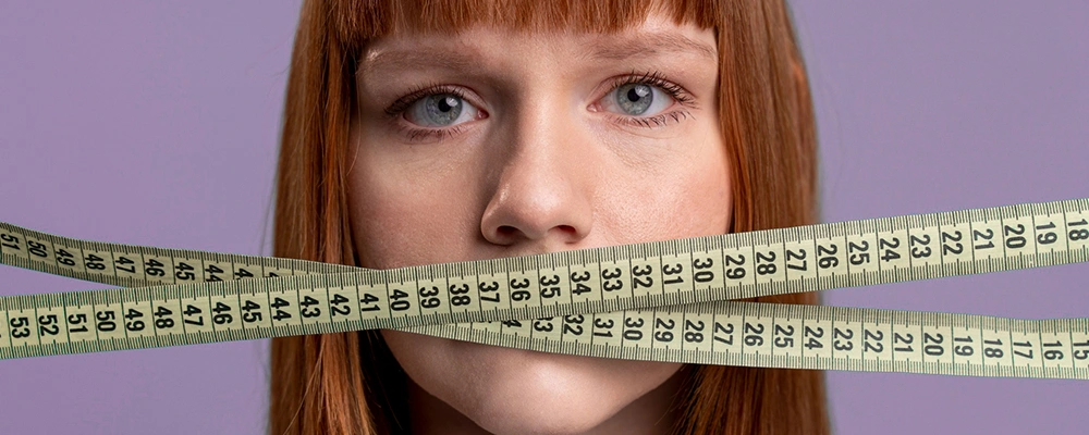 Woman gagged by measuring tape to depict being silenced by outdated BMI standards versus Waist-to-Hip Ratio facts