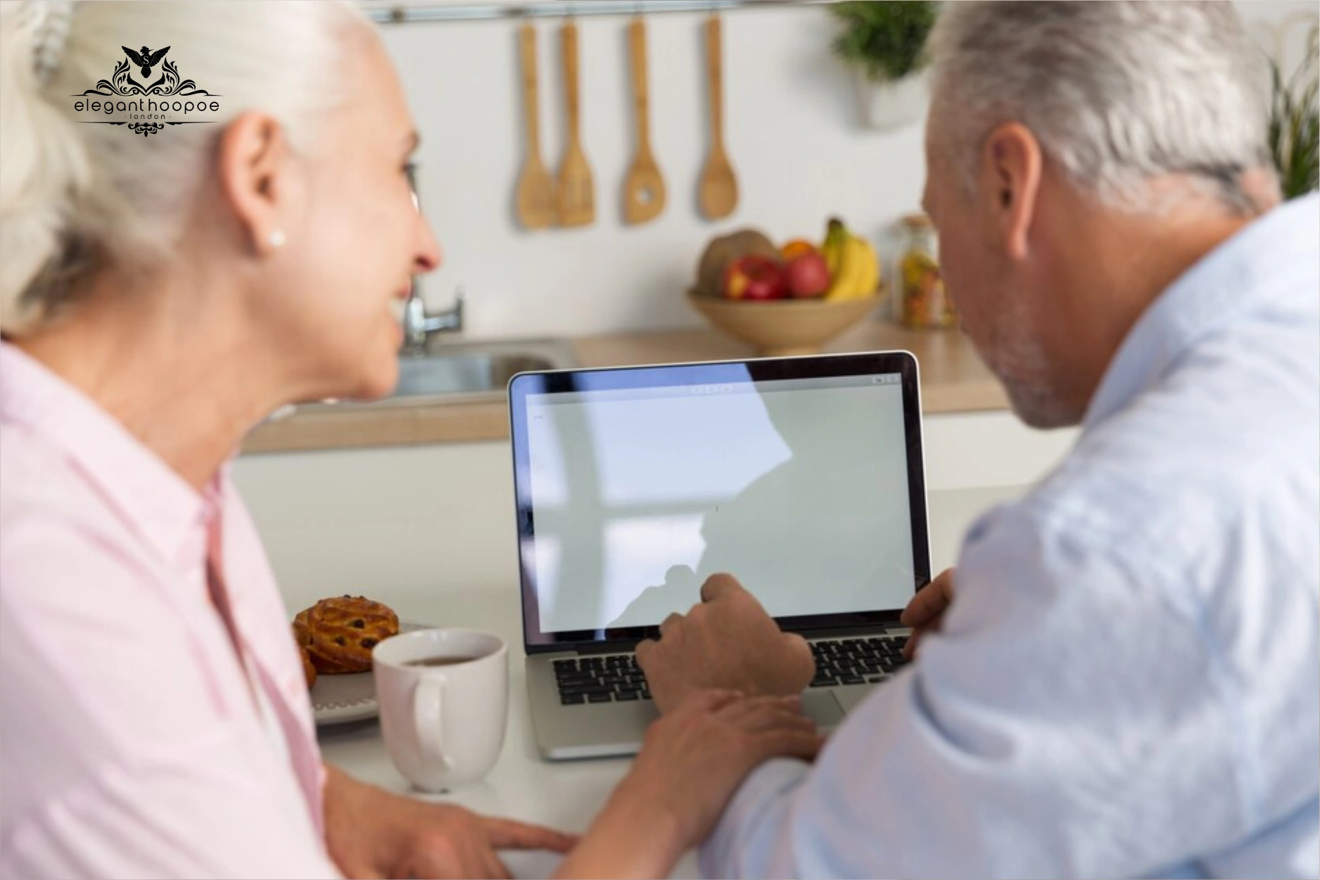 Seniors reviewing health info on laptop in kitchen