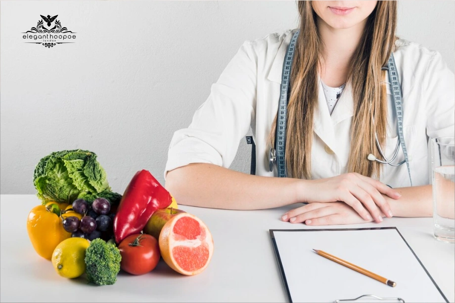 Nutritionist at desk with fruits, stethoscope and clipboard