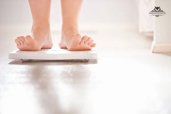 Close-up of feet standing on a white digital scale, symbolizing the start of a weight management journey