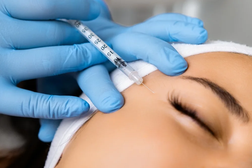 Aesthetic practitioner preparing Botox injection in a sterile environment